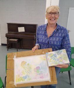 Basingstoke Student holding her painting of Jellyfish.