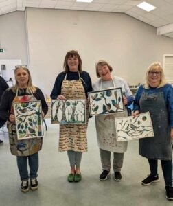 Four Basingstoke students holding their creations