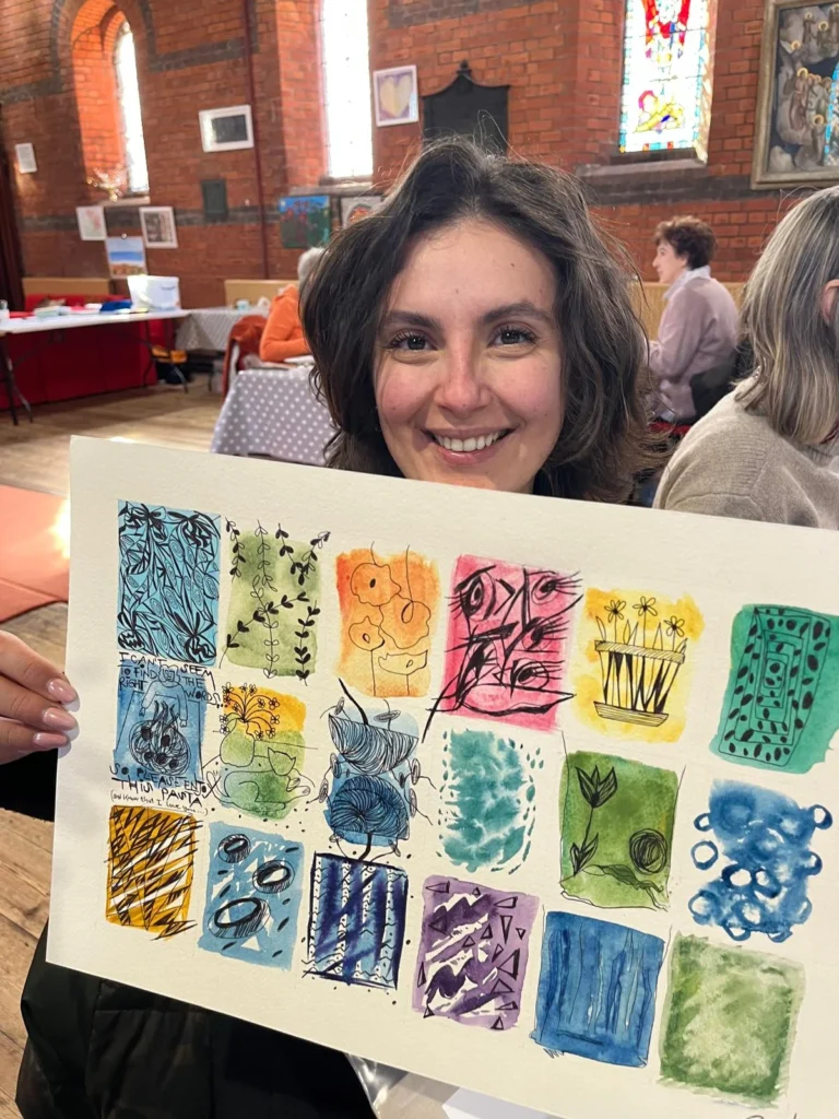 Student holding their beautiful art