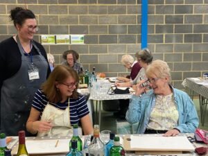 newbury-students-laughing-with-tutor